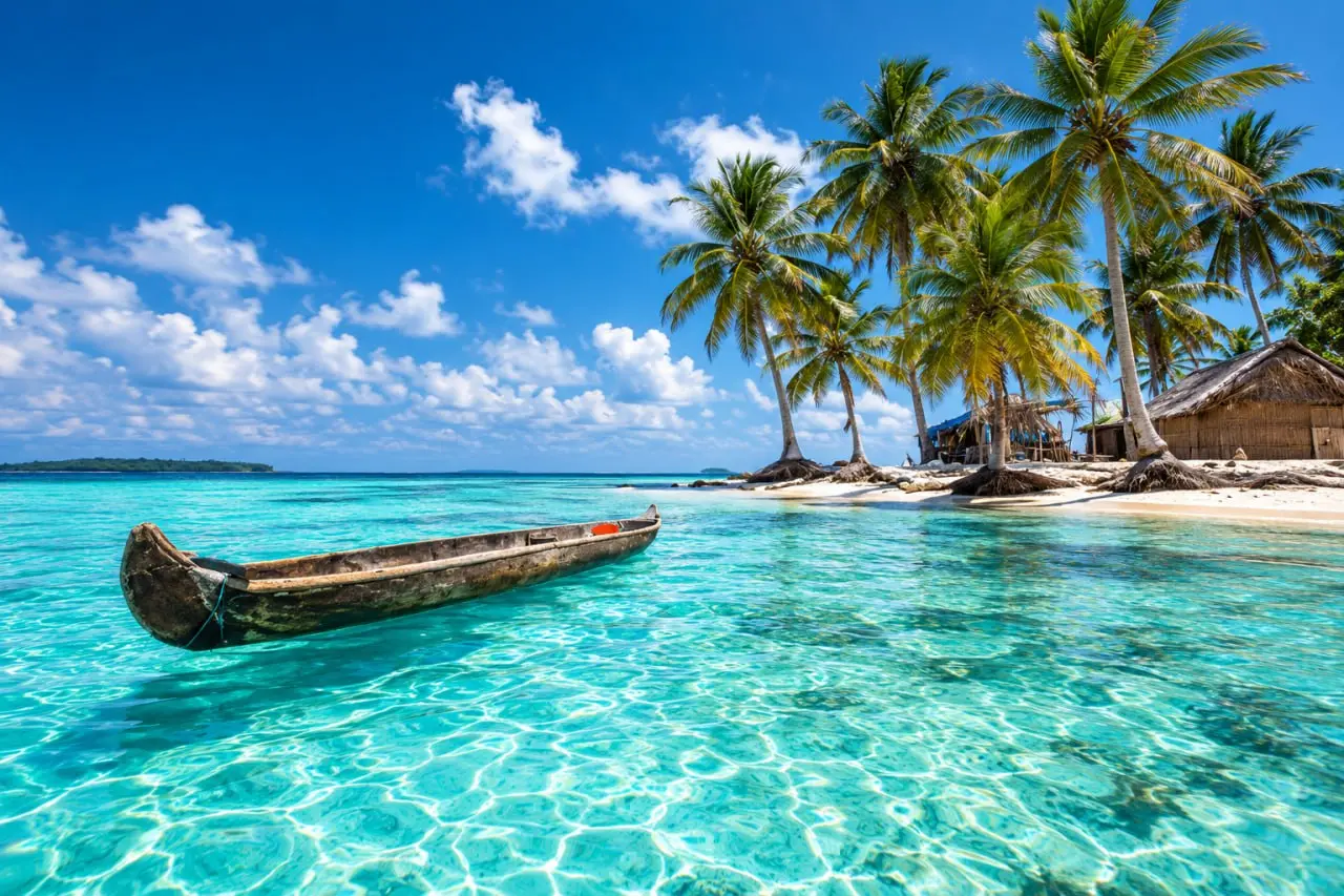 A dugout canoe in the shallows over rippled sand