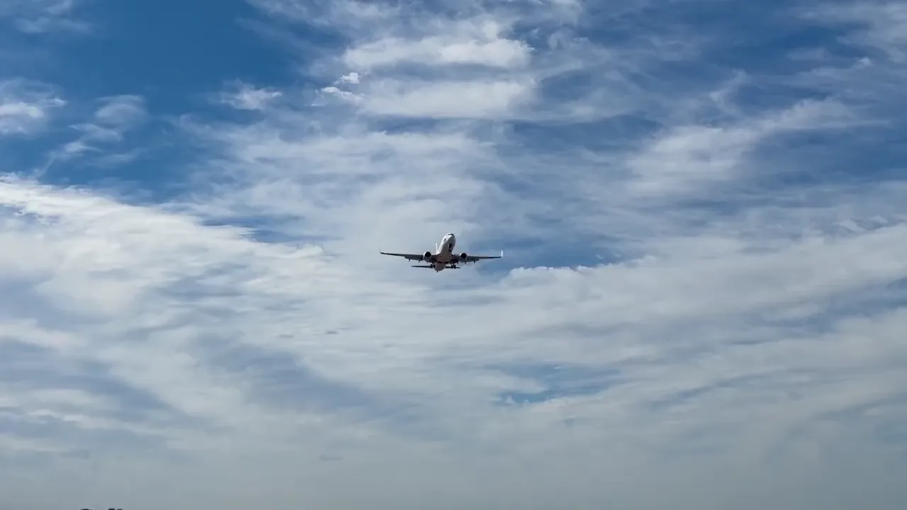 A passenger jet in the sky above the clouds