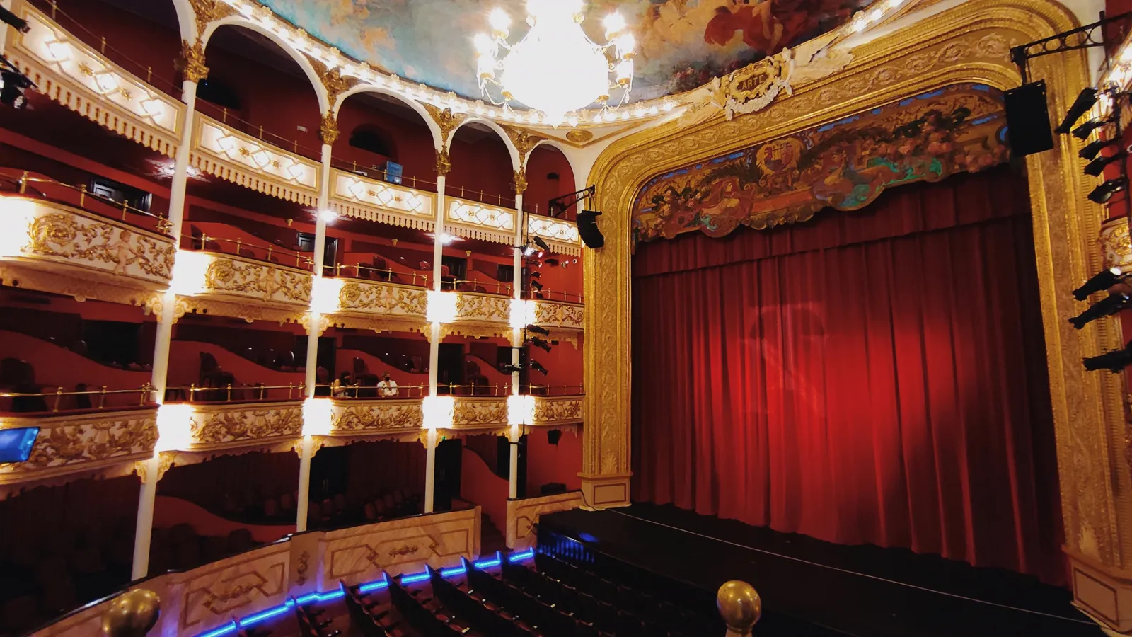 The auditorium of the National Theatre of Panama: tiers of boxes and a red curtain