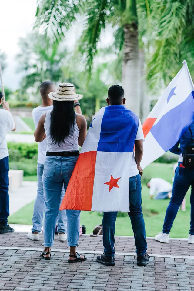 People wearing the flag of Panama over their shoulders at a city celebration
