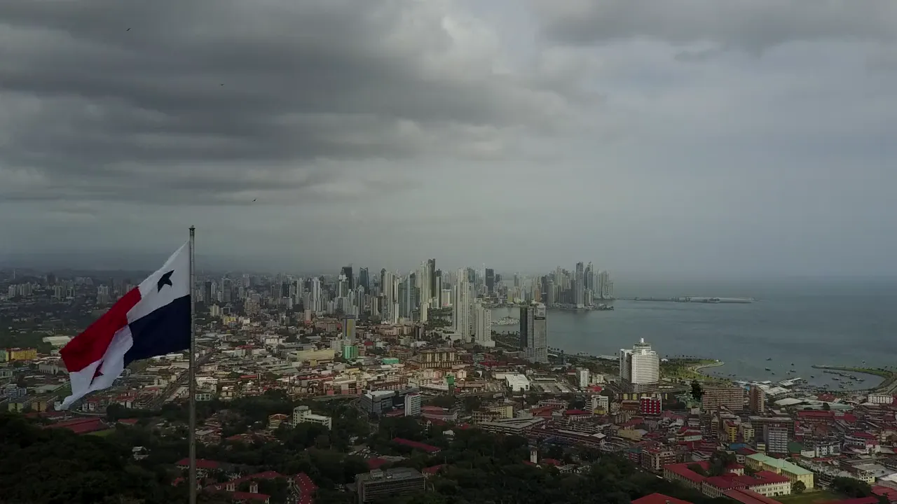 The flag of Panama on a hill above Panama City and the bay